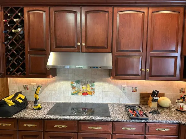 Close view of the new range hood and tile backsplash