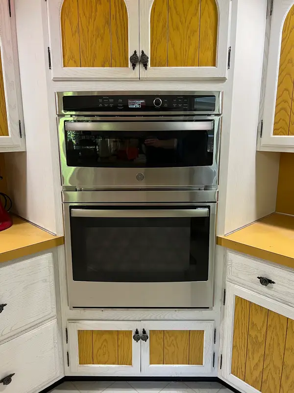 Stainless double wall oven installed in a painted cabinet surround