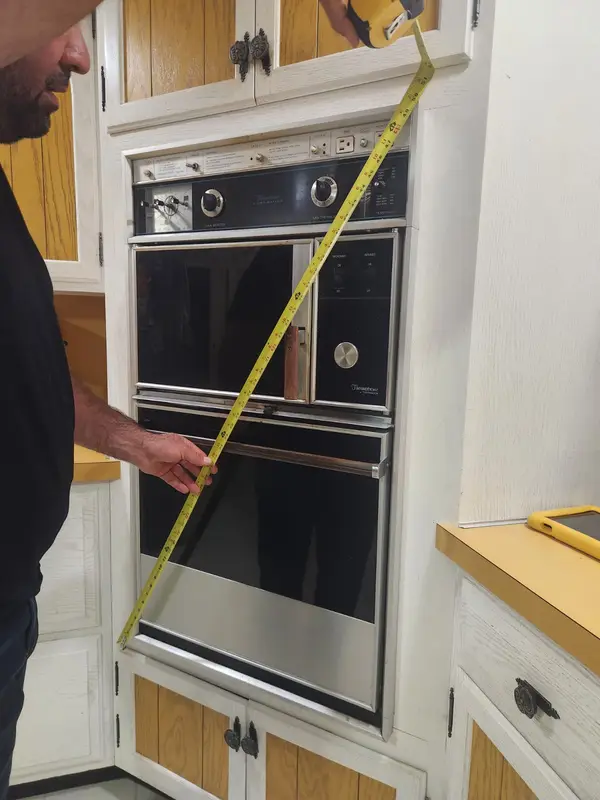 Measuring the old wall oven opening before the replacement